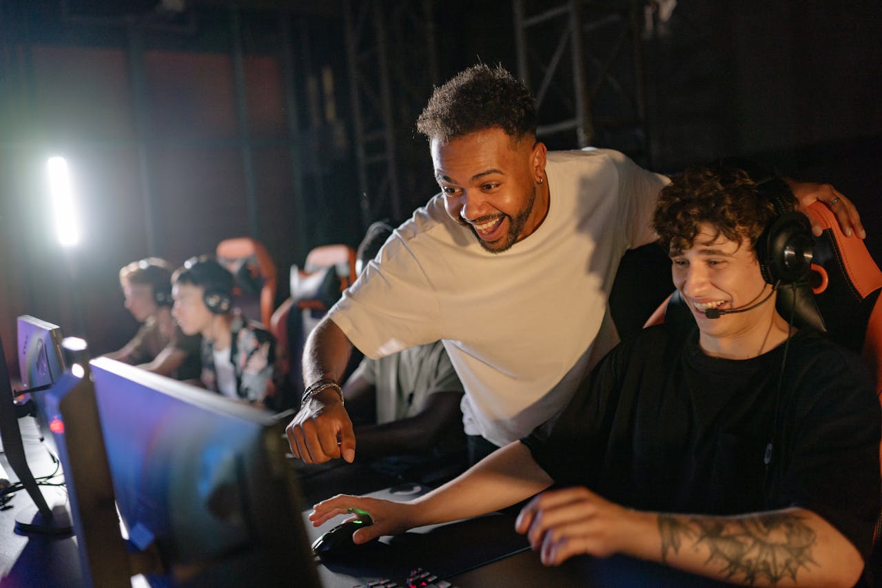 Gamers in a high-energy tournament setting enjoy competitive play with enthusiasm and teamwork.